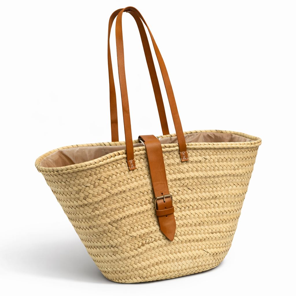 Woven bag with brown leather straps on a white background