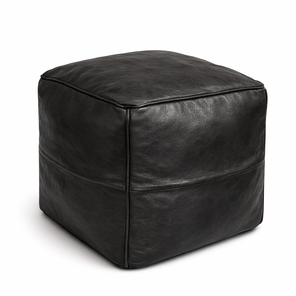 Black leather cube ottoman on a white background