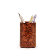 Brown thuya wood pen holder with three pens on a white background