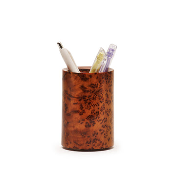 Brown thuya wood pen holder with three pens on a white background