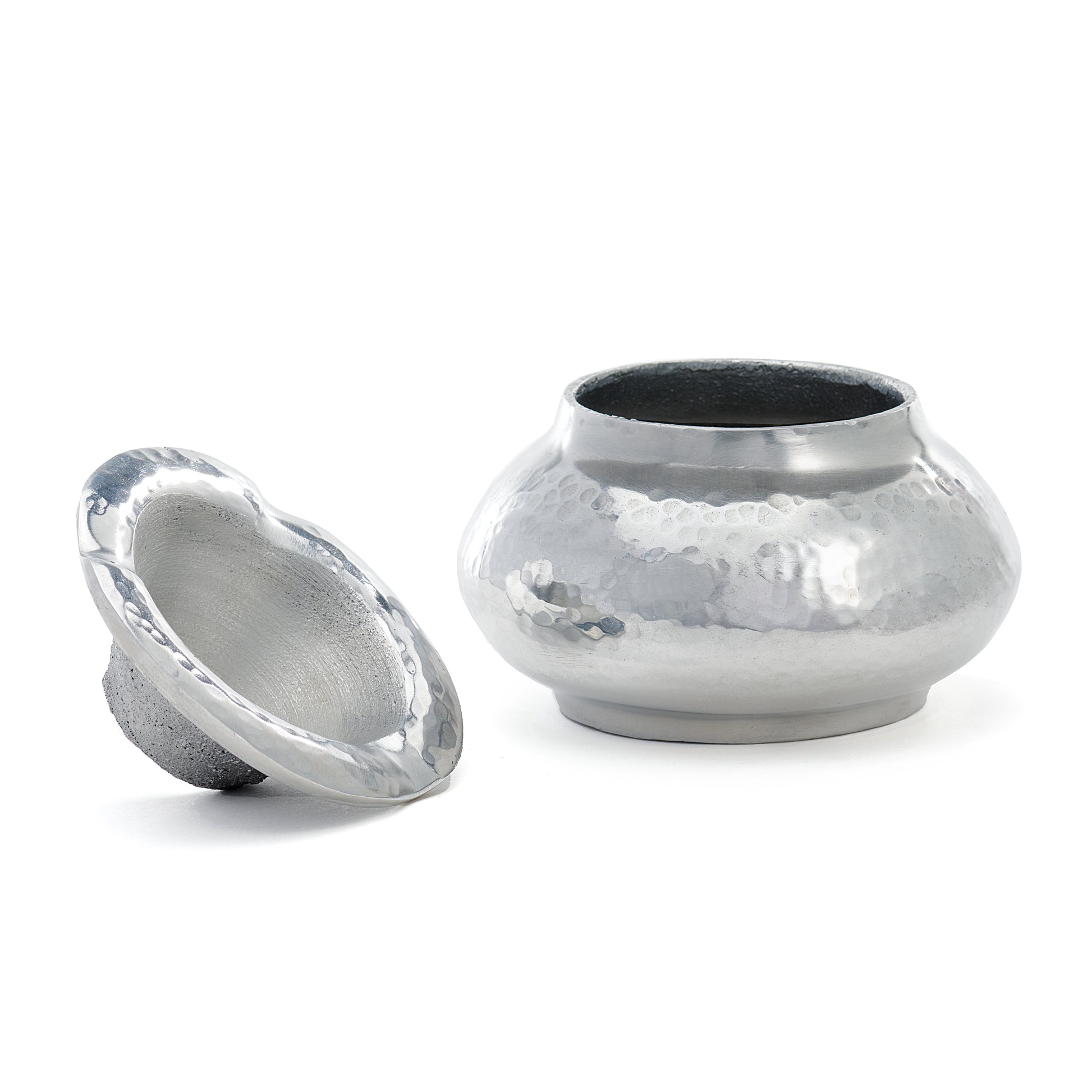 hand hammered aluminum metallic shiny ashtray with lid on a white background