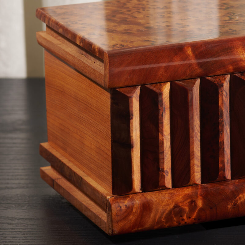 close up of thuya wooden puzzle box featuring wood burl veneer grain patterns with shiny polished surface