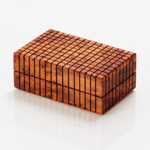 Thuya wooden puzzle box with a grid appearance that has a secret square that solves the puzzle and opens the compartment